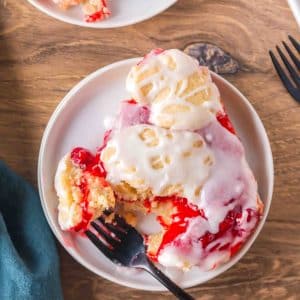 A spoonful of Cherry Pie Bar on a plate with a fork, showing the buttery layers. Hostess At Heart