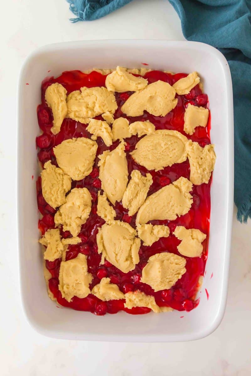 Dropping spoonfuls of dough over cherry pie filling before baking. Hostess At Heart