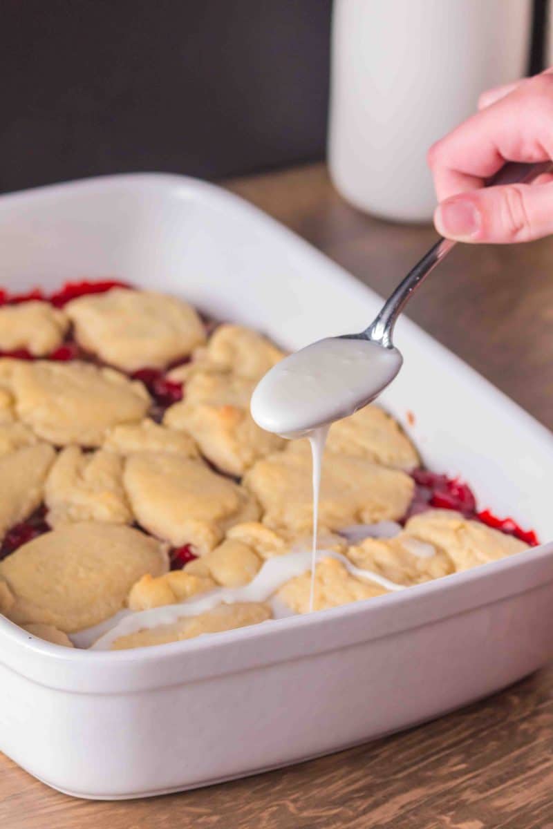 Drizzling vanilla glaze over warm Cherry Pie Bars. Hostess At Heart