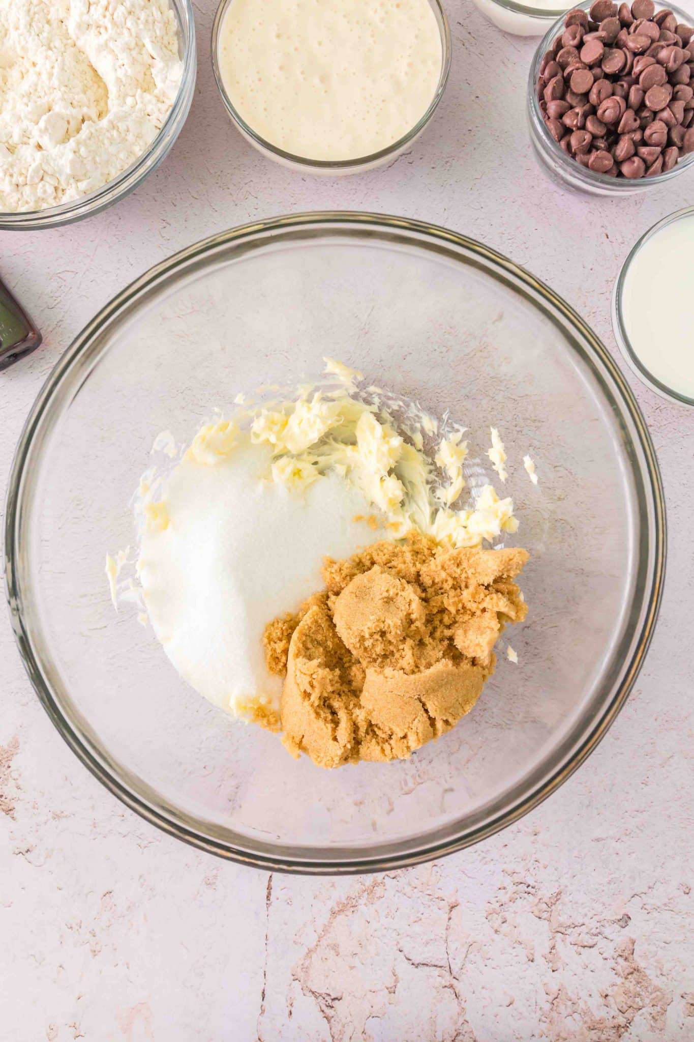 A mixing bowl filled with whipped butter, white and brown sugar for creaming. Hostess At Heart