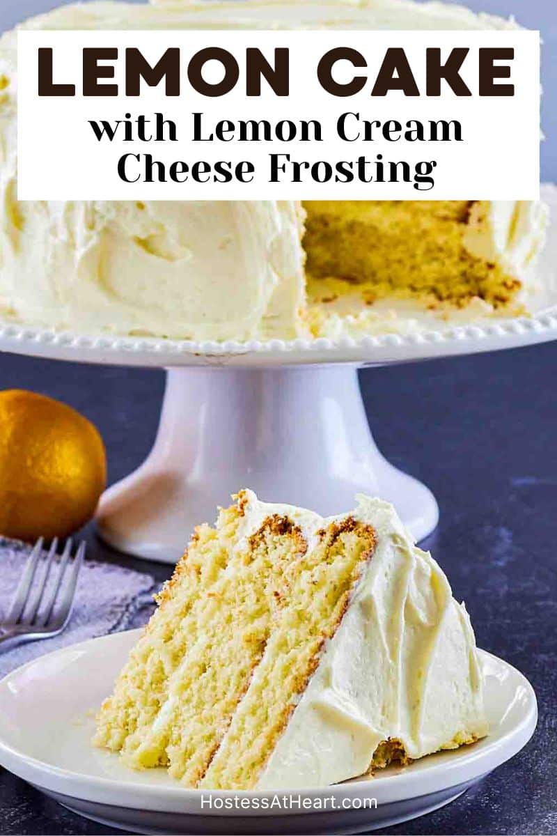 Image for Pinterest of a Slice of easy lemon cake with lemon cream cheese frosting on white plate showing moist yellow layers. The full cake is in the back on a cake stand. Hostess At Heart