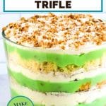 An image for Pinterest of a trifle bowl filled with layers of angelfood cake, pistachio cake, and whipped cream for an easy make-ahead St. Patrick's Dessert. Hostess At Heart