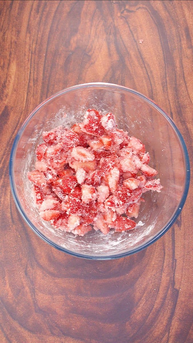 Fresh strawberries mixed with white sugar in a mixing bowl - Hostess At Heart