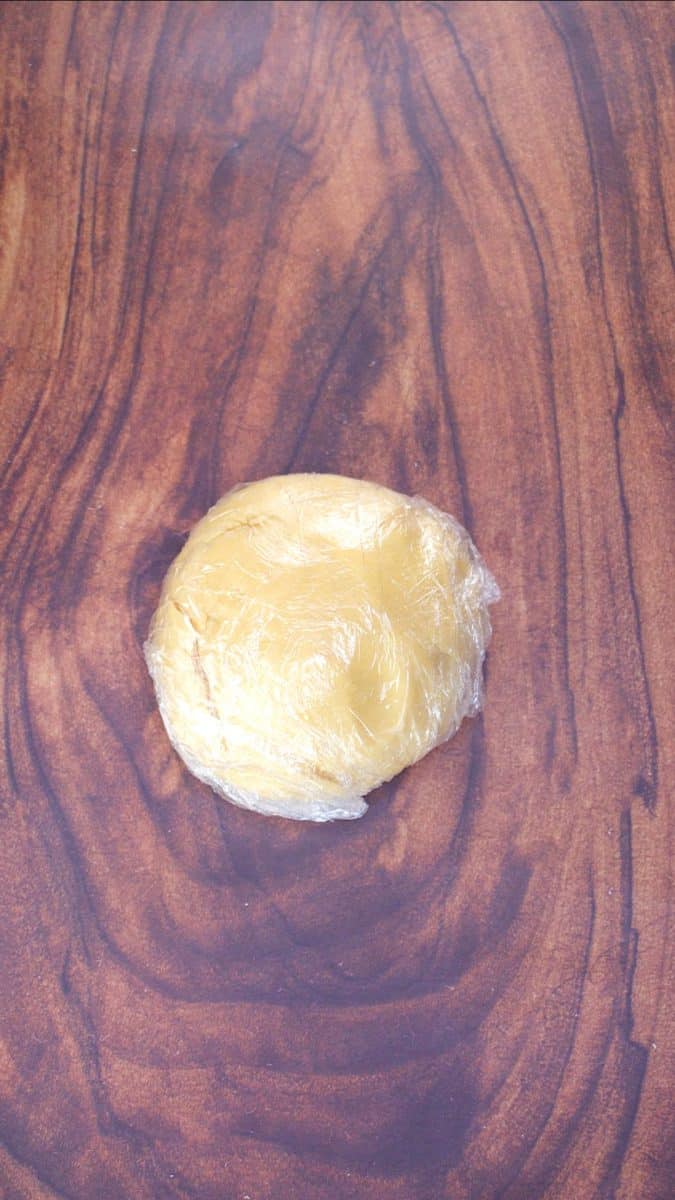 Pie dough covered in plastic dough to be chilled