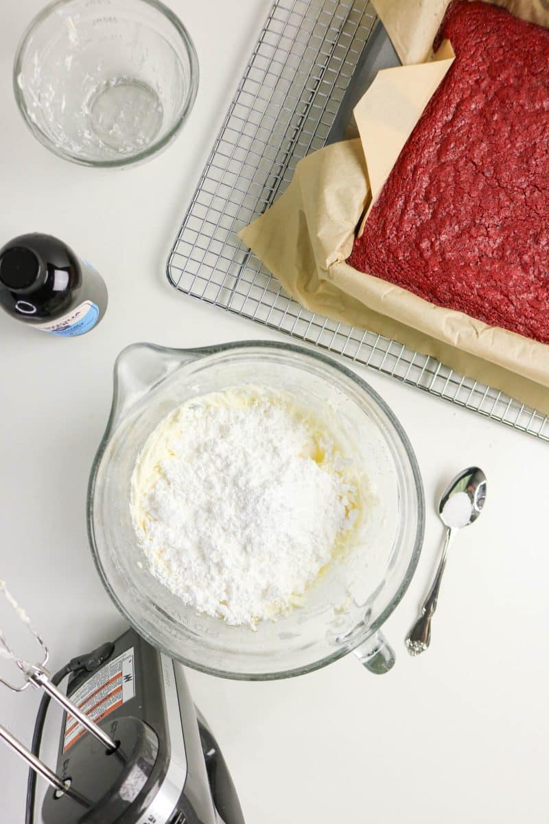 Powdered sugar topping cream cheese in a mixing bowl to make cream cheese frosting. Hostess At Heart