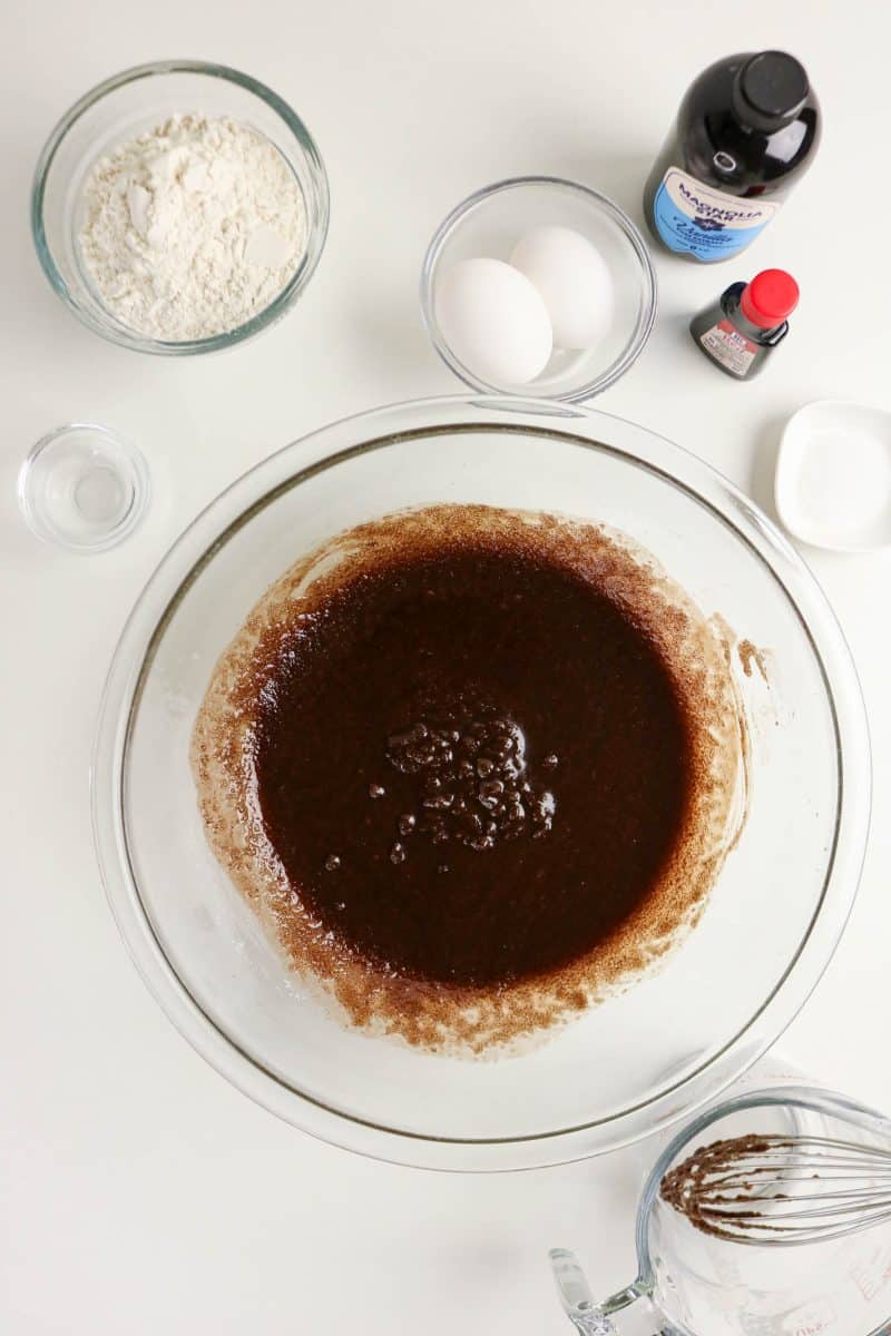 Cocoa added to a mixing bowl showing a brown batter before red food coloring is added to make a red velvet brownies recipe. Hostess At Heart