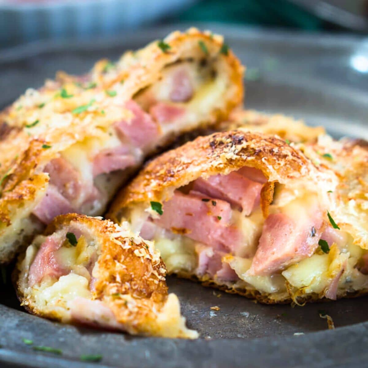 Golden calzone cut open showing the melted cheese and juicy diced ham. Hostess At Heart