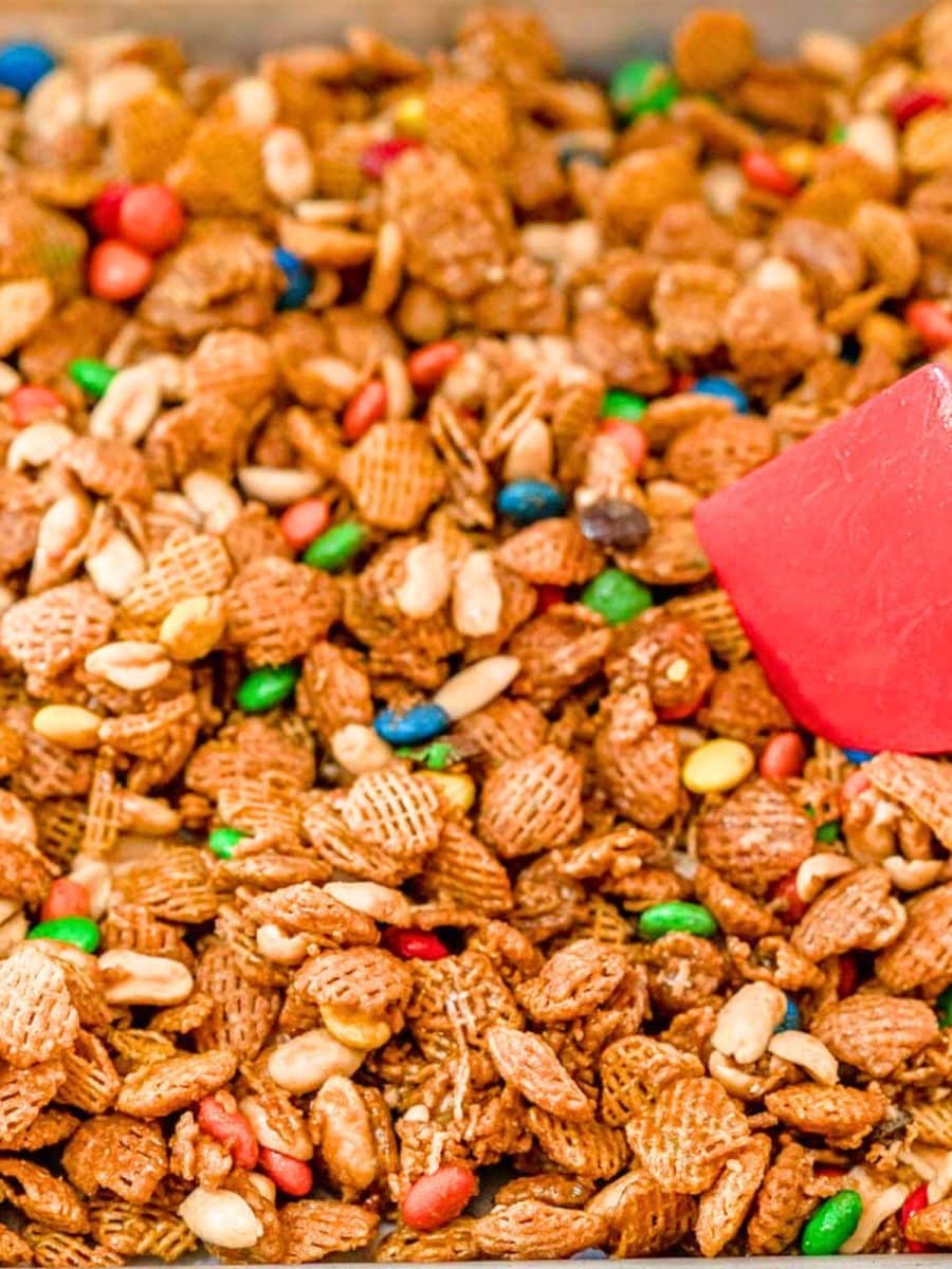 Hot Fingerfood Crispix Snack Mix spread out onto a baking sheet so it can dry. Hostess At Heart