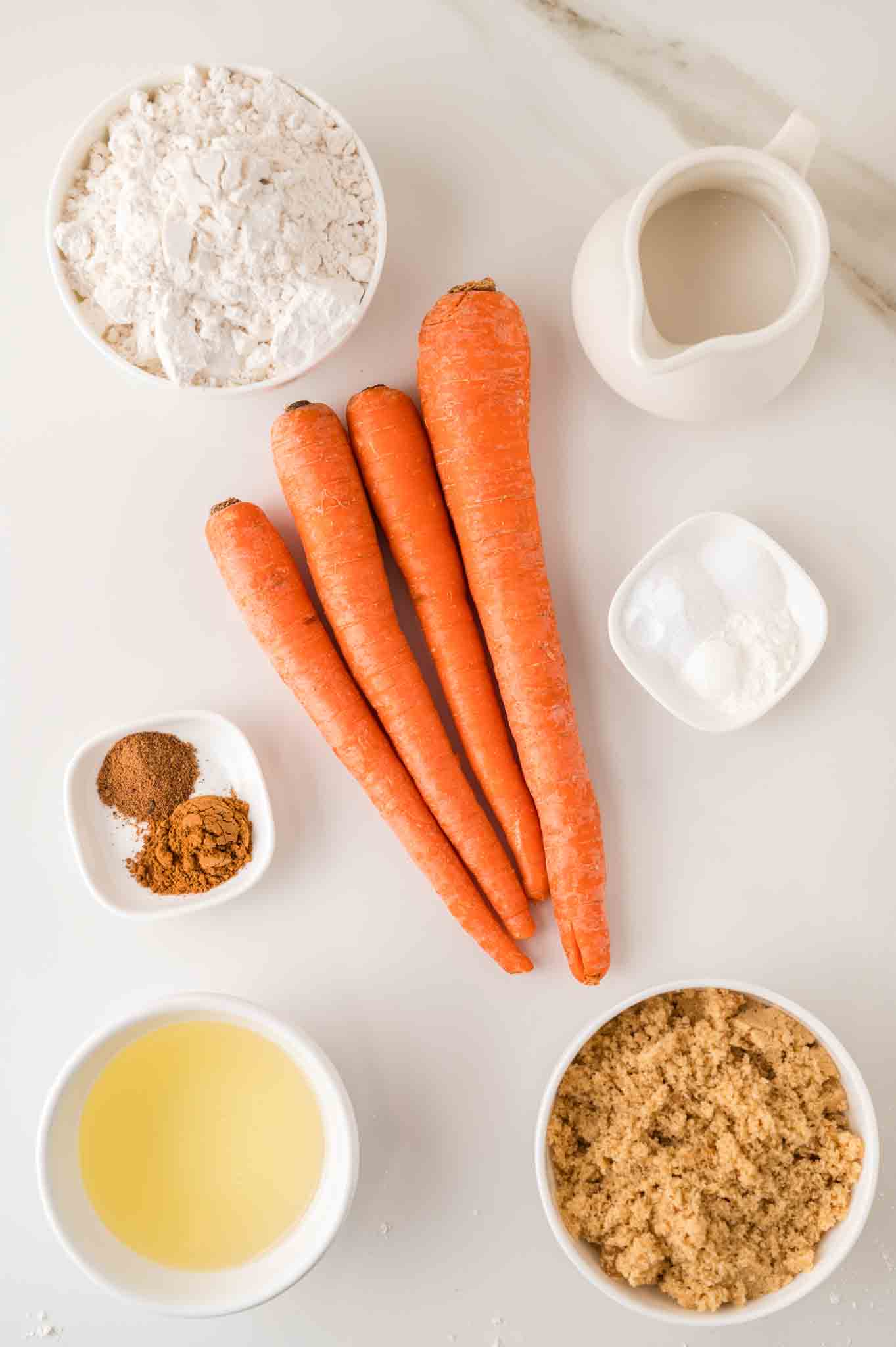 Carrot Cake Muffins recipe ingredients including carrots, cinnamon, brown sugar, cinnamon, flour, baking powder, baking soda, and vegetable oil. Hostess At Heart