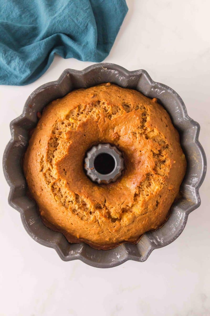 Golden brown carrot bundt cake with pineapple cooling in the pan. Hostess At Heart