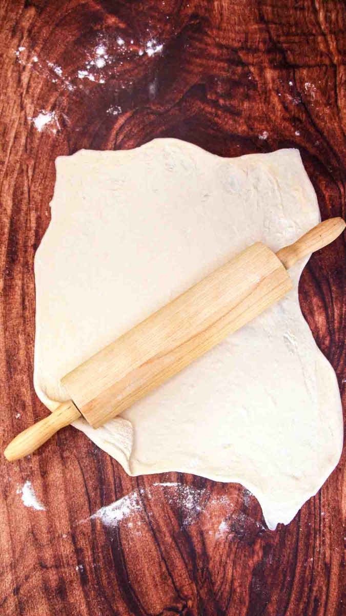 Pizza dough rolled flat before shaping into circles for ham and cheese calzones. Hostess At Heart