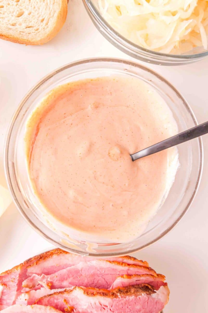 A top down view of a mixing bowl filled with homemade Thousand Island dressing. Hostess At Heart