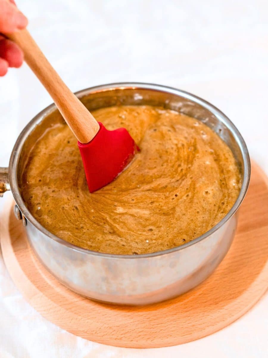 A saucepan filled with frothy caramel sauce for homemade sweet crispix finger food. Hostess At Heart