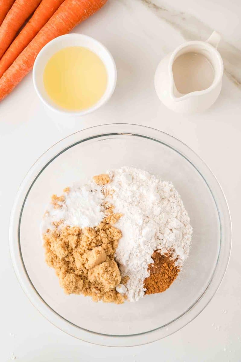 Dry ingredients ready to be whisked together in a large mixing bowl for carrot muffins. Hostess At Heart