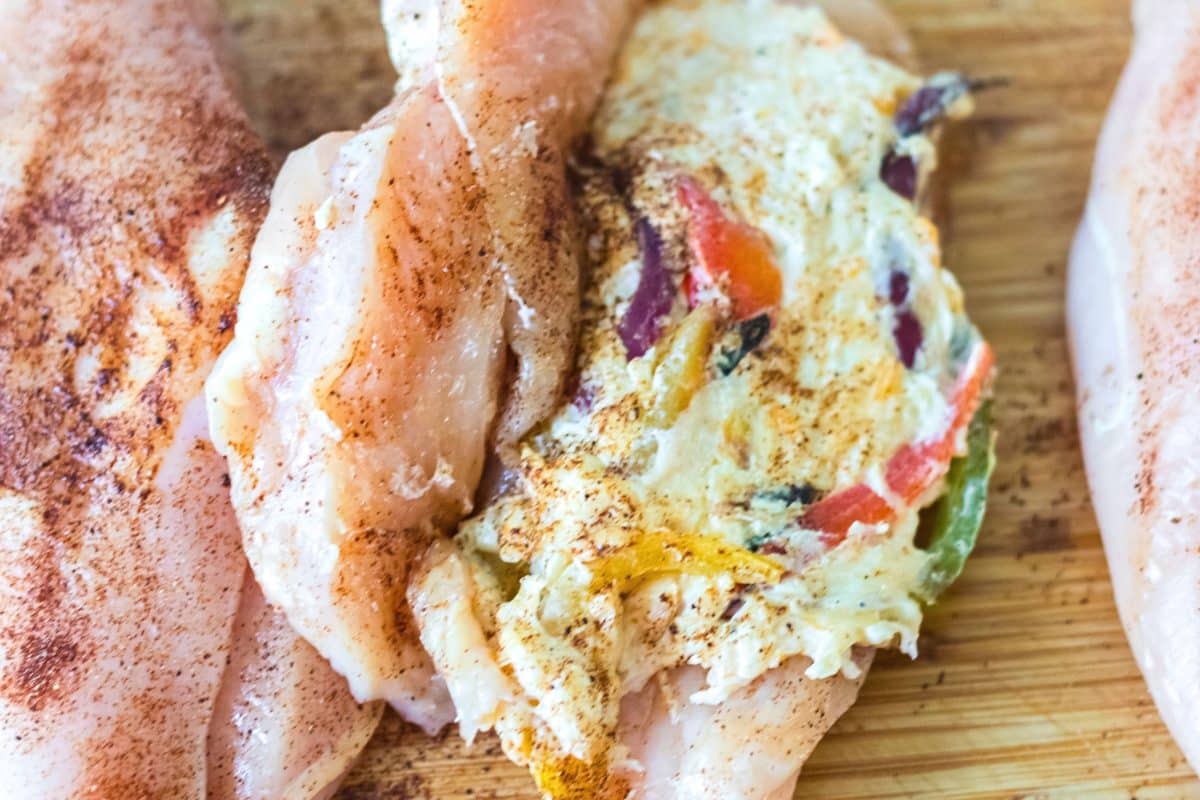 A sliced chicken breast stuffed with cheesy fajita filling and seasoned with fajita seasoning. Hostess At Heart