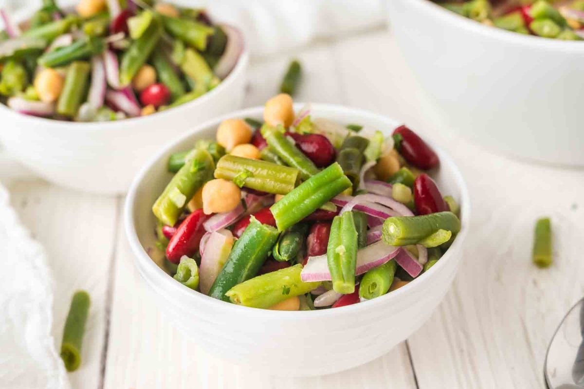 Two dishes of three bean salad, perfect no-cook summer potluck side dish. Hostess At Heart