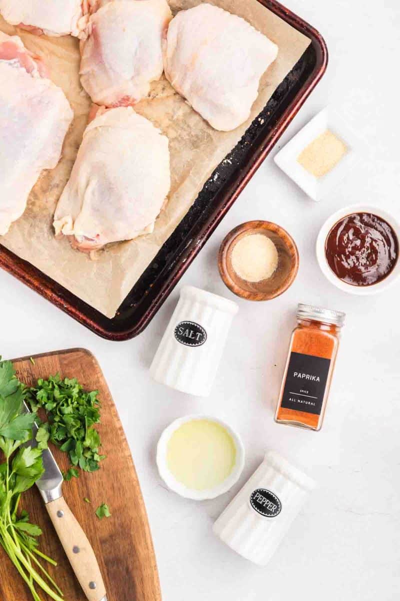 Baked Chicken Thighs Recipe Ingredients: Bone-in, skin-on chicken thighs, avocado oil, paprika, salt, pepper, garlic powder, onion powder, and BBQ sauce. Hostess At Heart