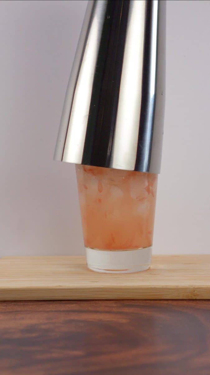 A shaker cup fit over a Tom Collins glass to mix a Paloma cocktail together. Hostess At Heart