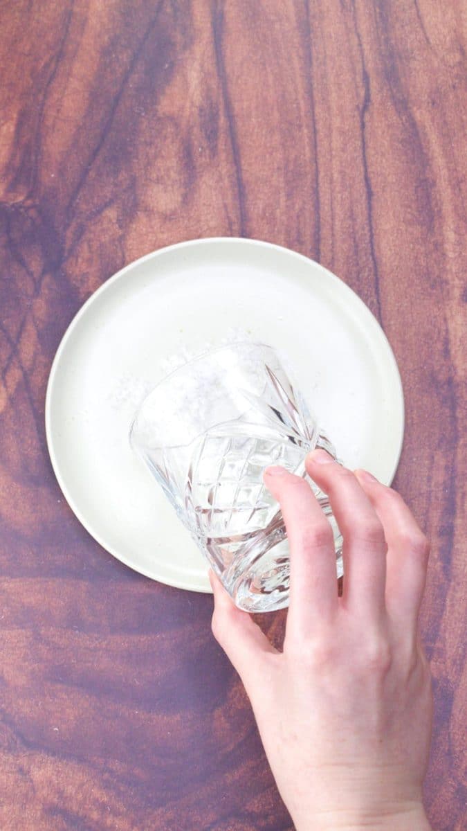 Dipping the edge of a lime rimmed glass into salt for garnishing. Hostess At Heart