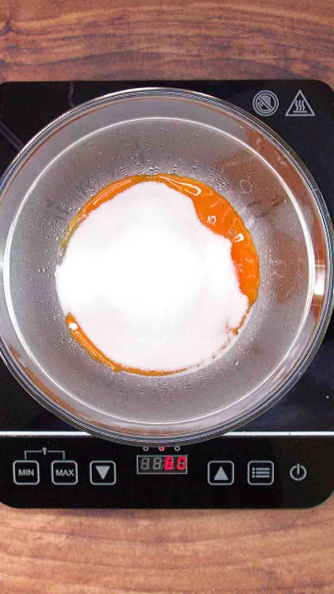 Egg yolks and sugar cooking in a double boiler for Esterhazy Torte hazelnut buttercream. Hostess At Heart