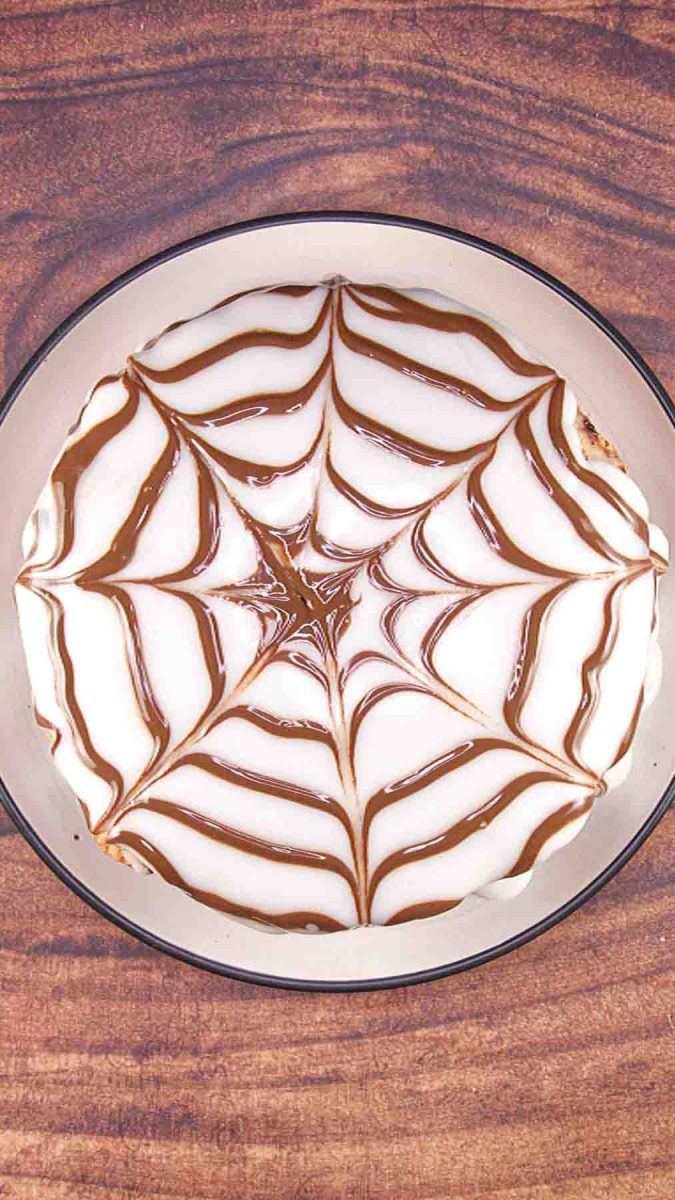 Top down view of a spiderweb design on top of an Esterhazy Cake. Hostess At Heart