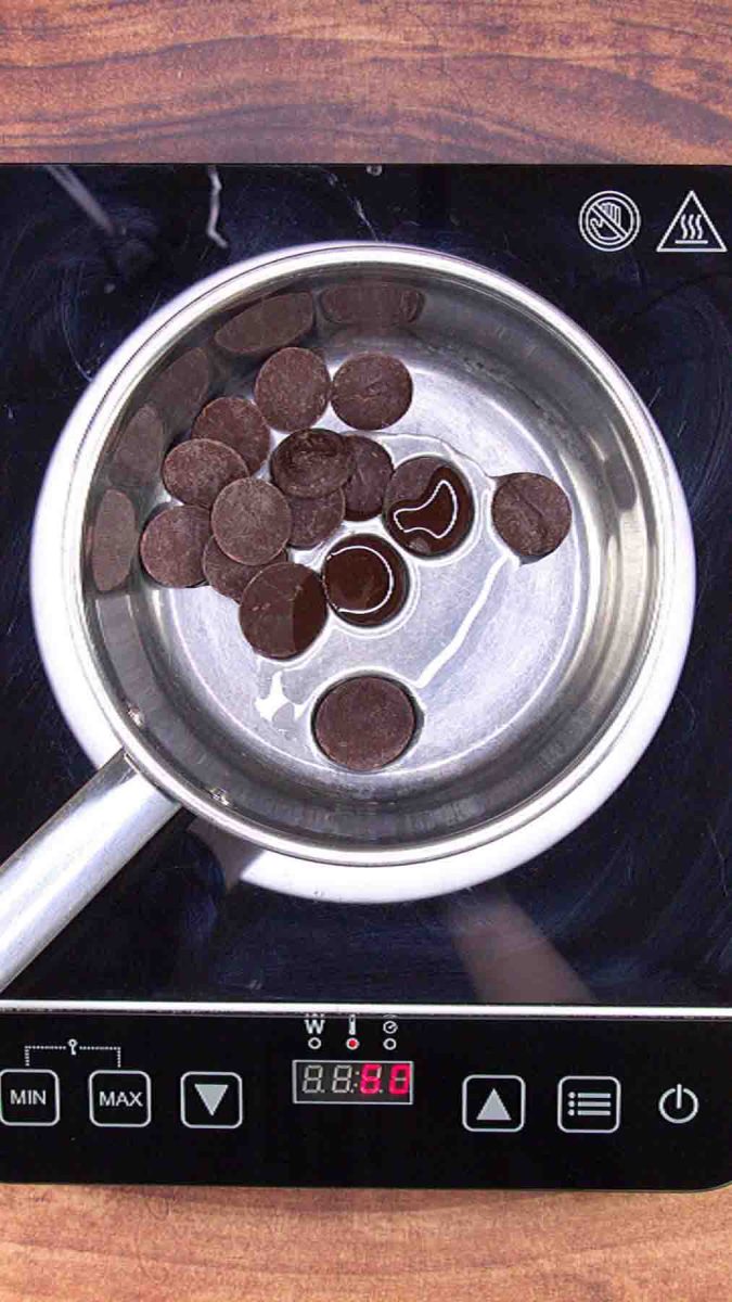 Chocolate and oil mixed together to create a thin chocolate mixture for piping a pattern on top of an Esterhazy Torte. Hostess At Heart