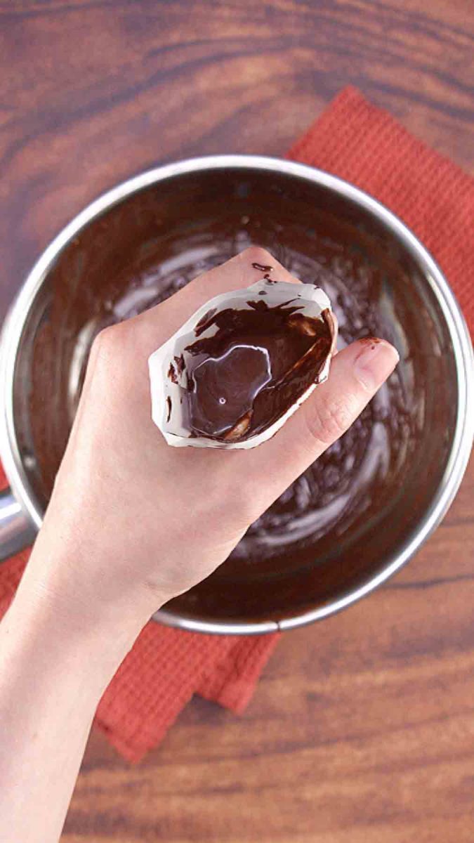 A piping bag filled with a thin chocolate icing for piping on top of a Hungarian Layer Cake.