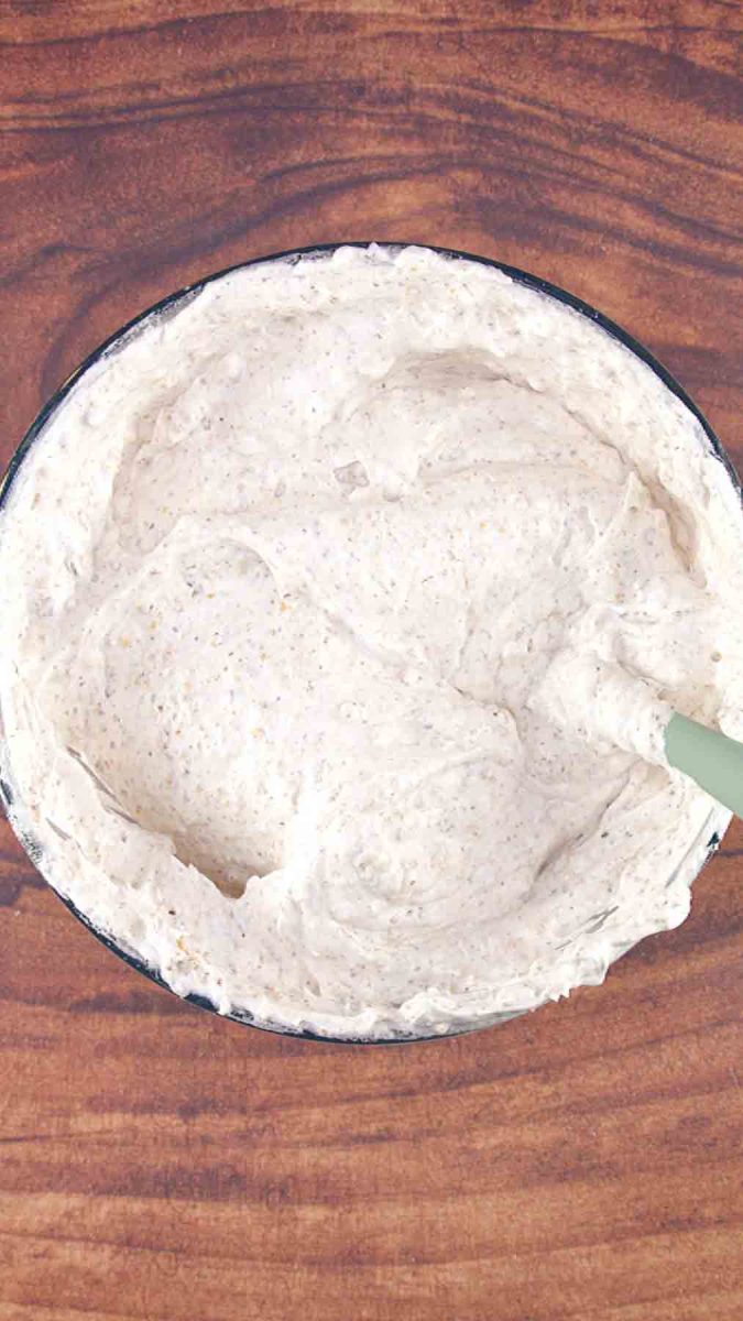 Thick hazelnut dacquoise batter make up of crushed hazelnuts and stiff egg whites in a mixing bowl. Hostess At Heart