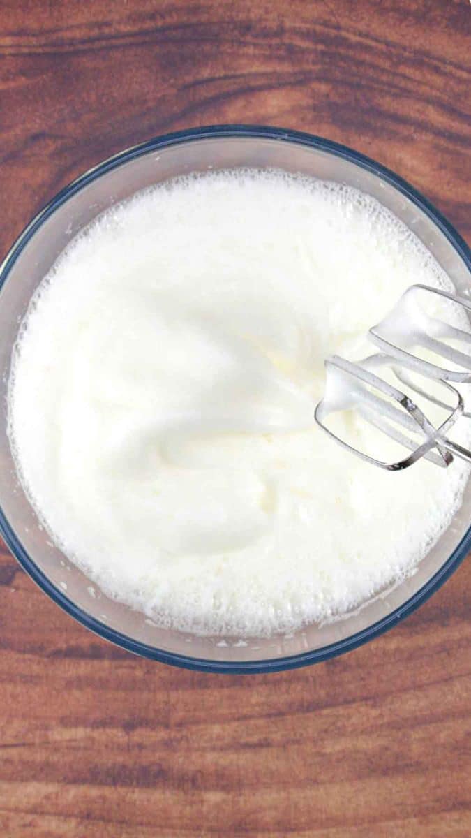 Egg whites beaten to stiff peaks in a stand mixer for Esterhazy cake dacquoise layers Hostess At Heart