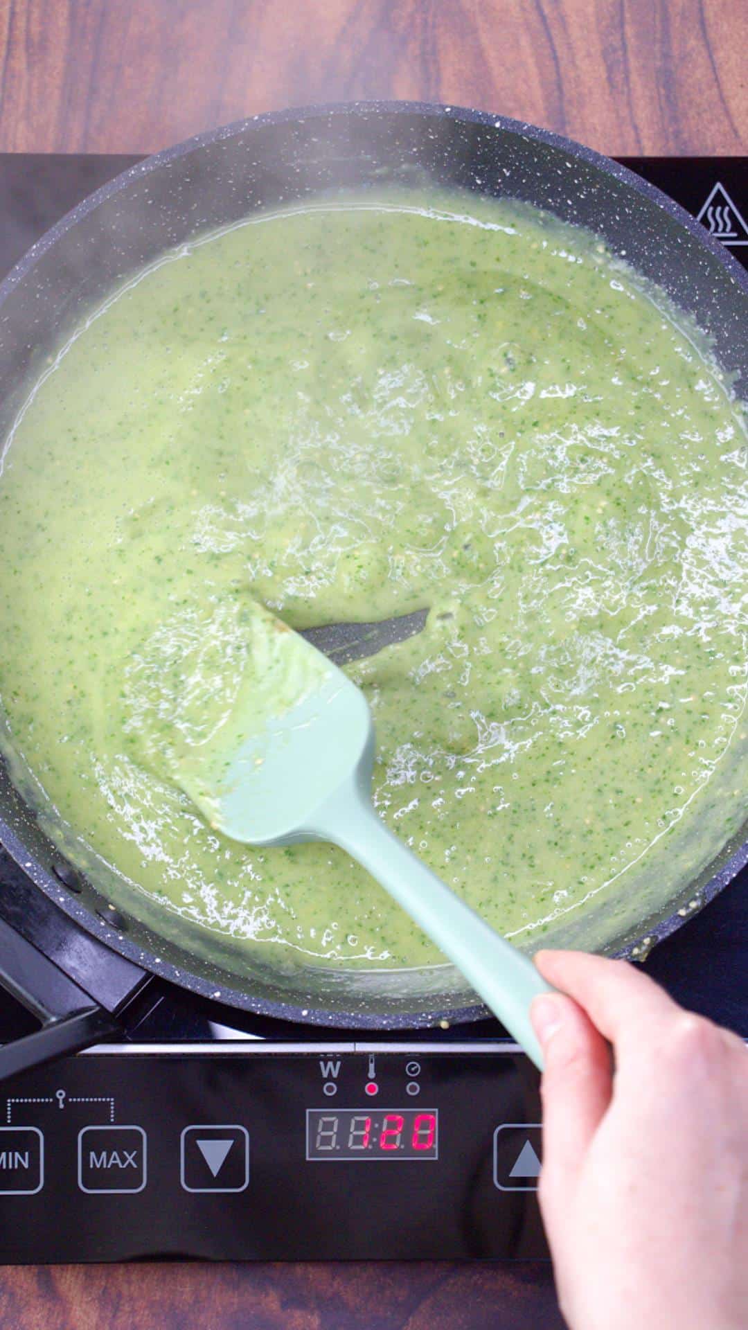 A large skillet filled with thick Green mole sauce ready to be combined with chicken for enchiladas. Hostess At Heart
