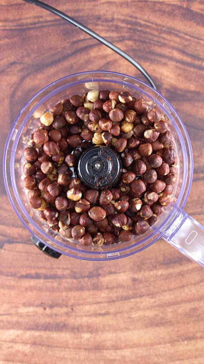 Toasted hazelnuts in a food processer for making a Esterhazy Torte recipe. Hostess At Heart