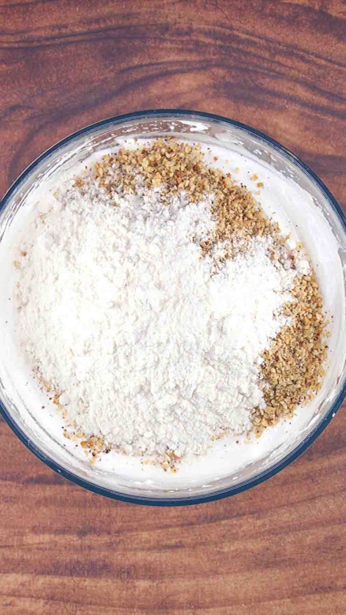 A dacquoise batter showing flour and crushed hazelnut to egg whites. Hostess At Heart