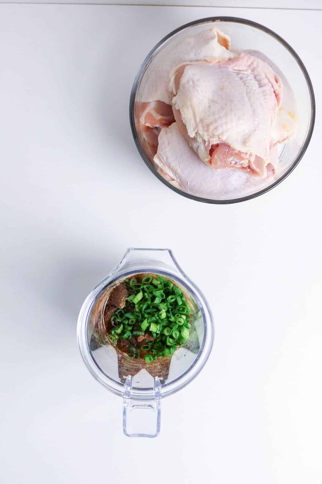 Jerk chicken marinade with green onions, garlic, and spices in a mixing bowl ready to be blended together. Hostess At Heart