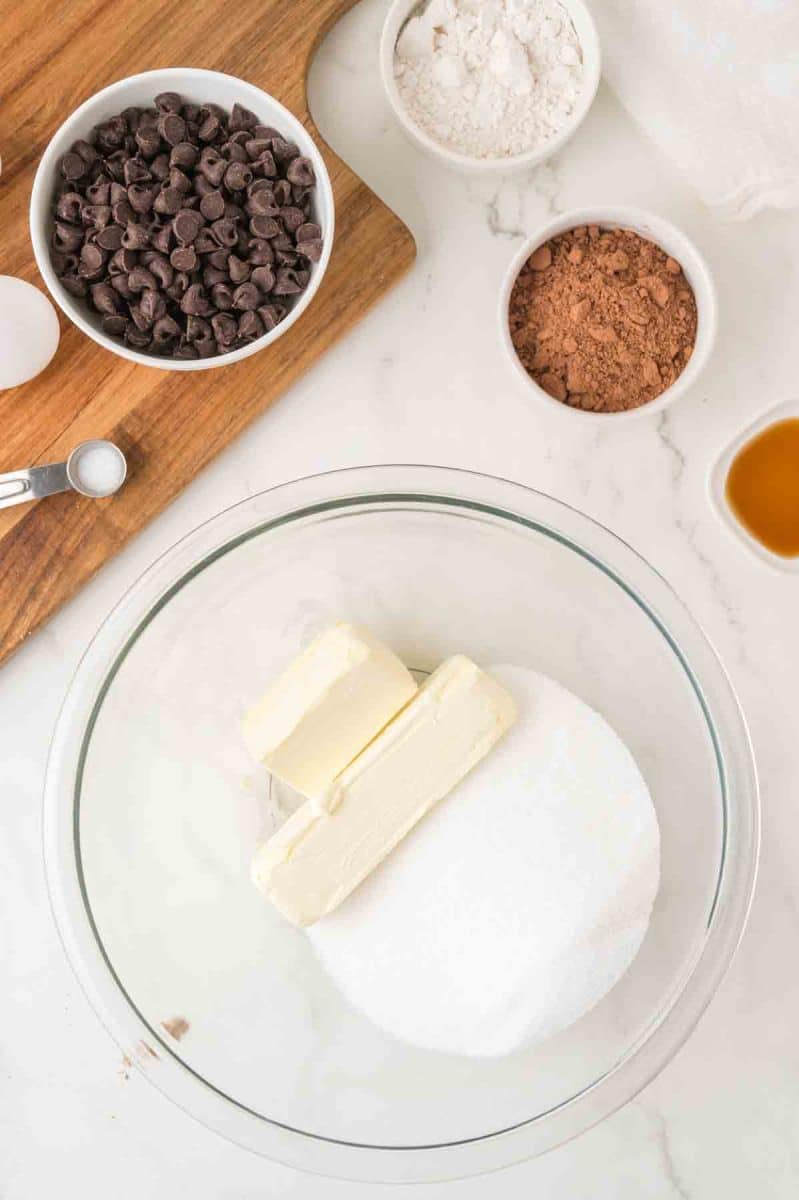 A mixing bowl filled with white sugar and butter ready to be whipped together. Hostess At Heart