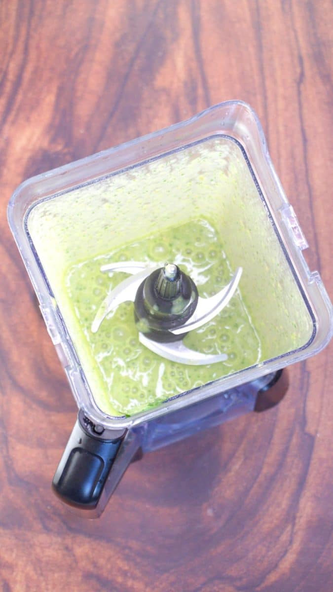 Top down view of Green mole sauce in a blender. Hostess At Heart