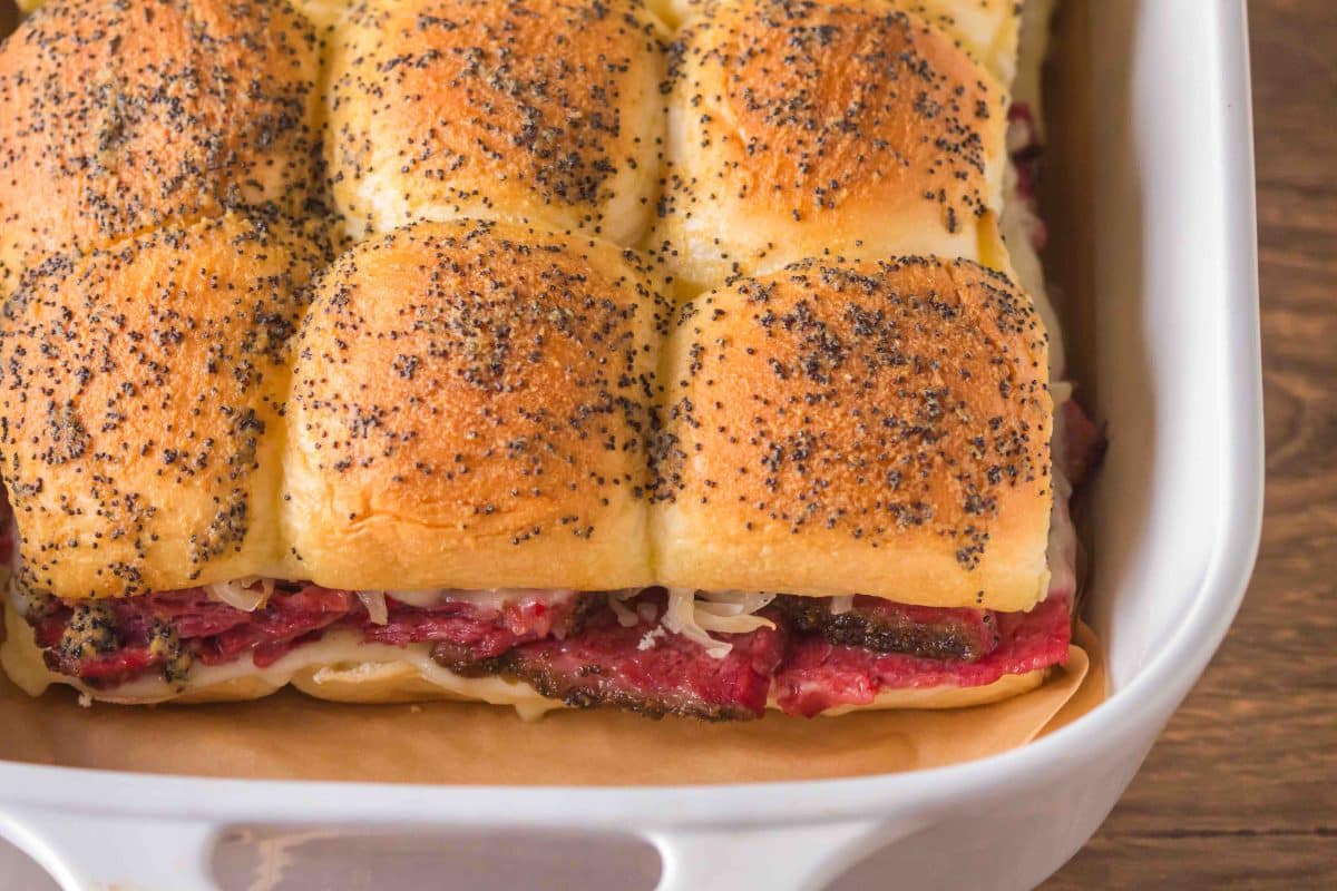 top down view of golden brown corned beef sliders on Hawaiian rolls ready to serve at a party. Hostess At Heart