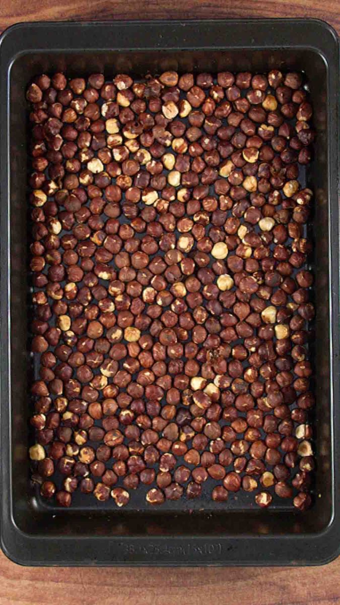 Hazelnuts toasting on a baking sheet for Esterhazy Torte hazelnut layers. Hostess At Heart