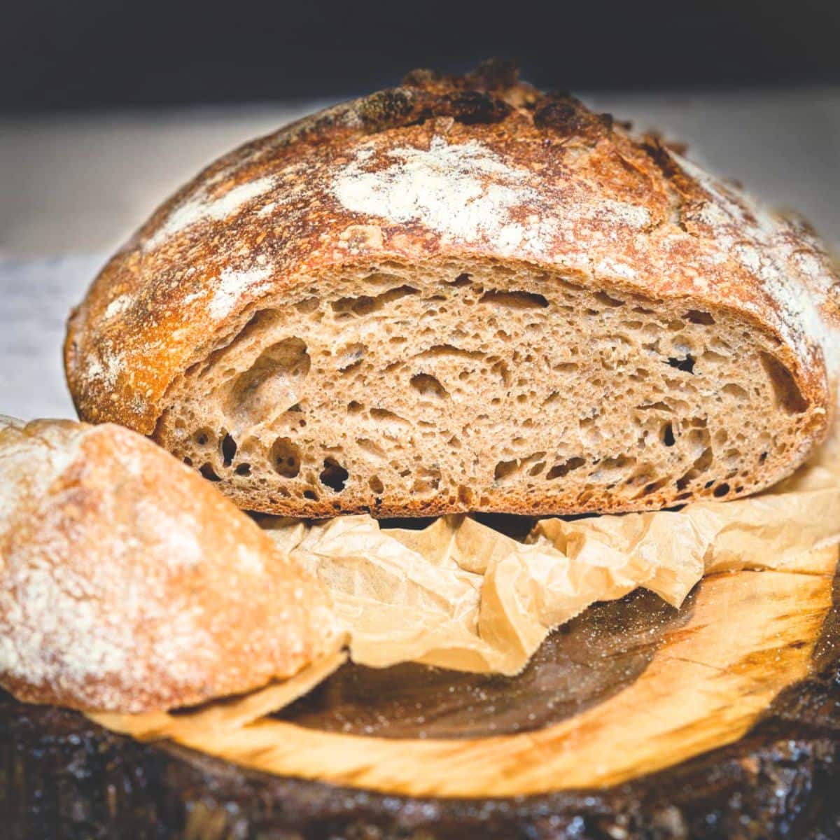 Front view of a sliced loaf of sourdough spelt bread baked golden brown showing a soft crumb. Hostess At Heart