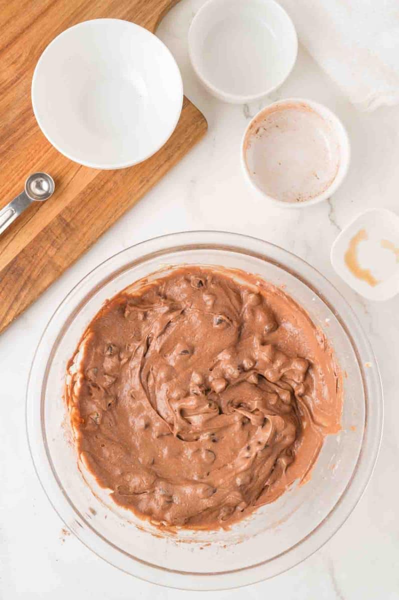 a mixing bowl filled with chocolate fudge pie batter mixed together before adding it to a pie crust for baking. Hostess At Heart