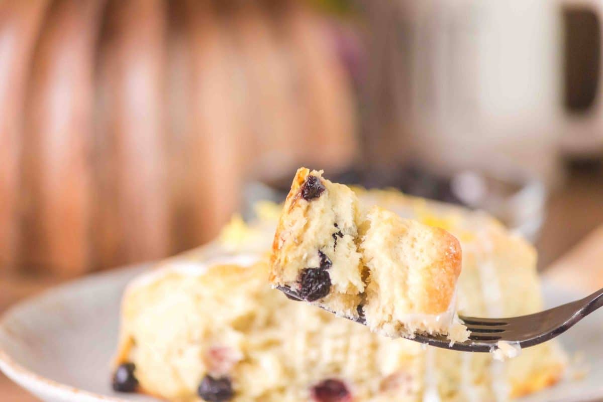 A forkful of a buttery blueberry bisquit loaded with dried blueberrys. Hostess At Heart