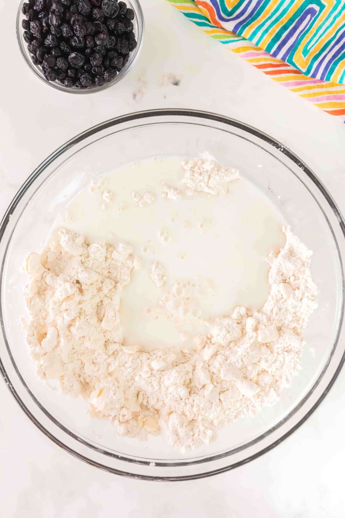 Milk added to a mixing bowl filled with biscuit dough recipe. Hostess At Heart