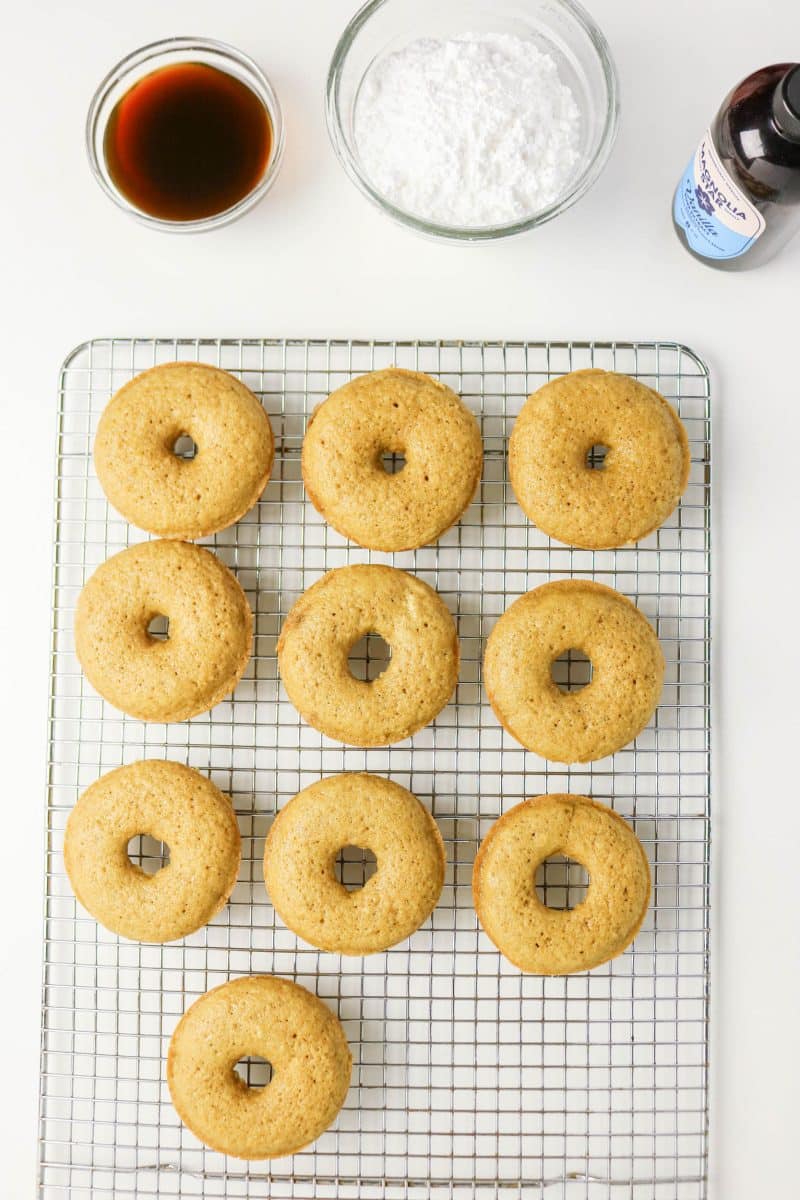 Baked coffee cake donuts cooling on a wire rack before glazing. Hostess At Heart