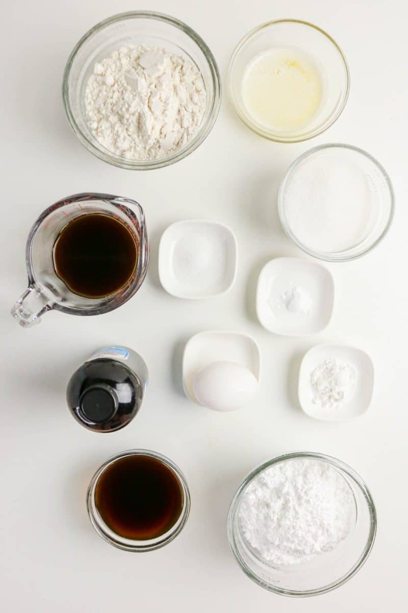 Ingredients to make oven baked glazed coffee donuts: Flour, Sugar baking powder, brewed coffee, egg, vanilla, bakiing soda, salt, powdered sugar, and butter. Hostess At Heart