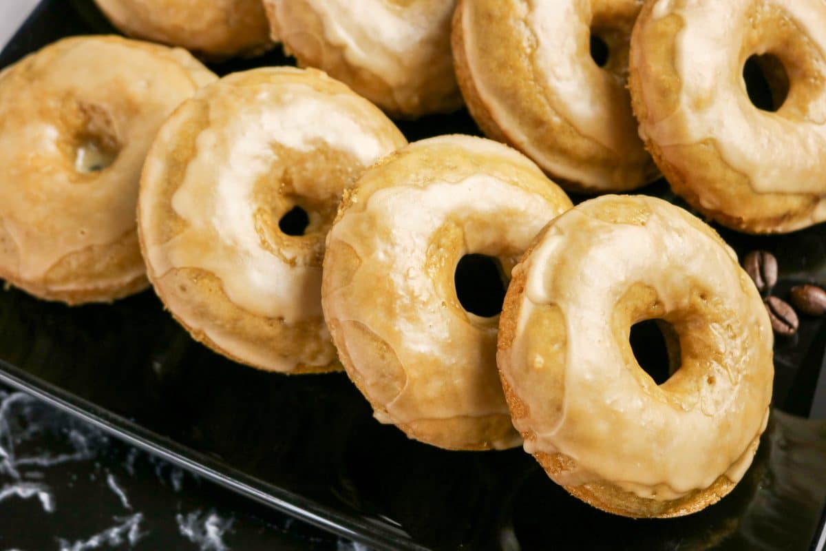 Sideview of oven-baked coffee donuts stacked in a row for serving. Hostess At Heart