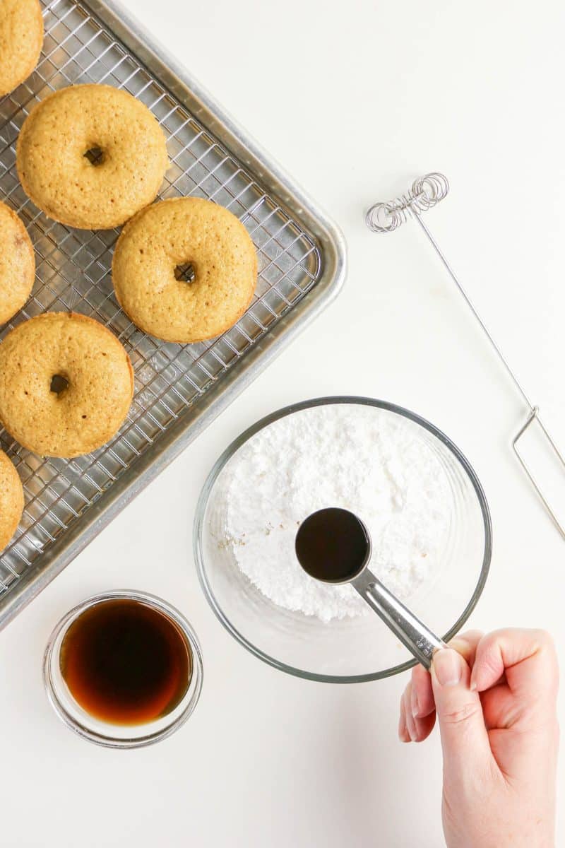 A mixing bowl filled with powdered sugar ready to be whisked with brewed coffee and vanilla to make coffee glaze. Hostess At Heart