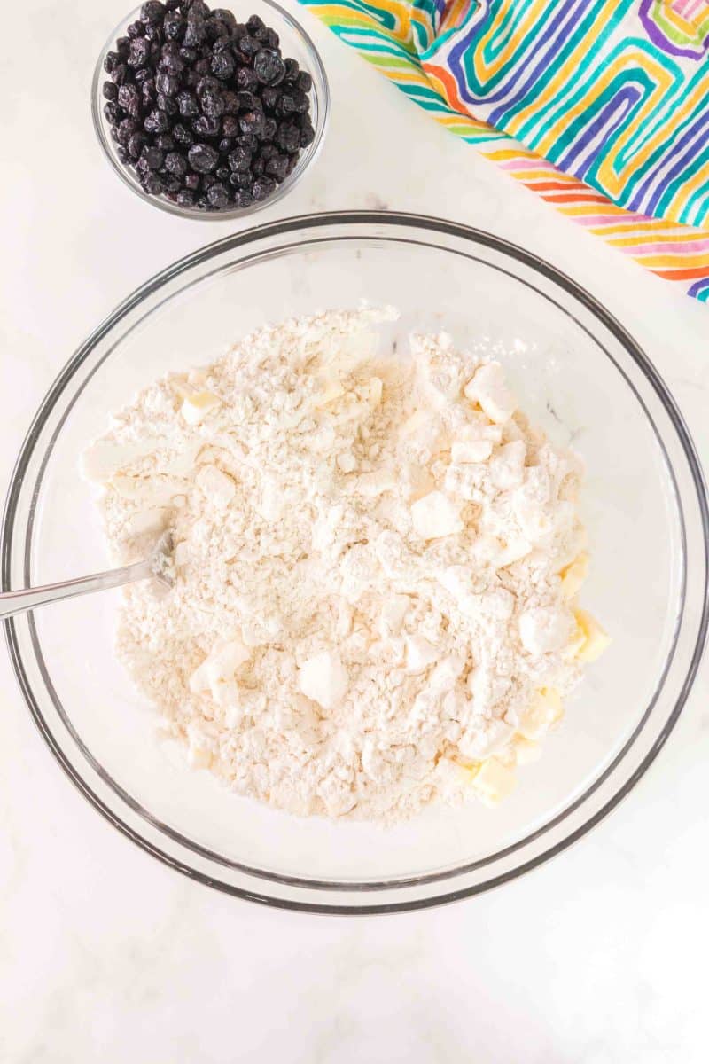 Cold butter crumbled into flour mixture for flaky blueberry biscuits. Hostess At Heart