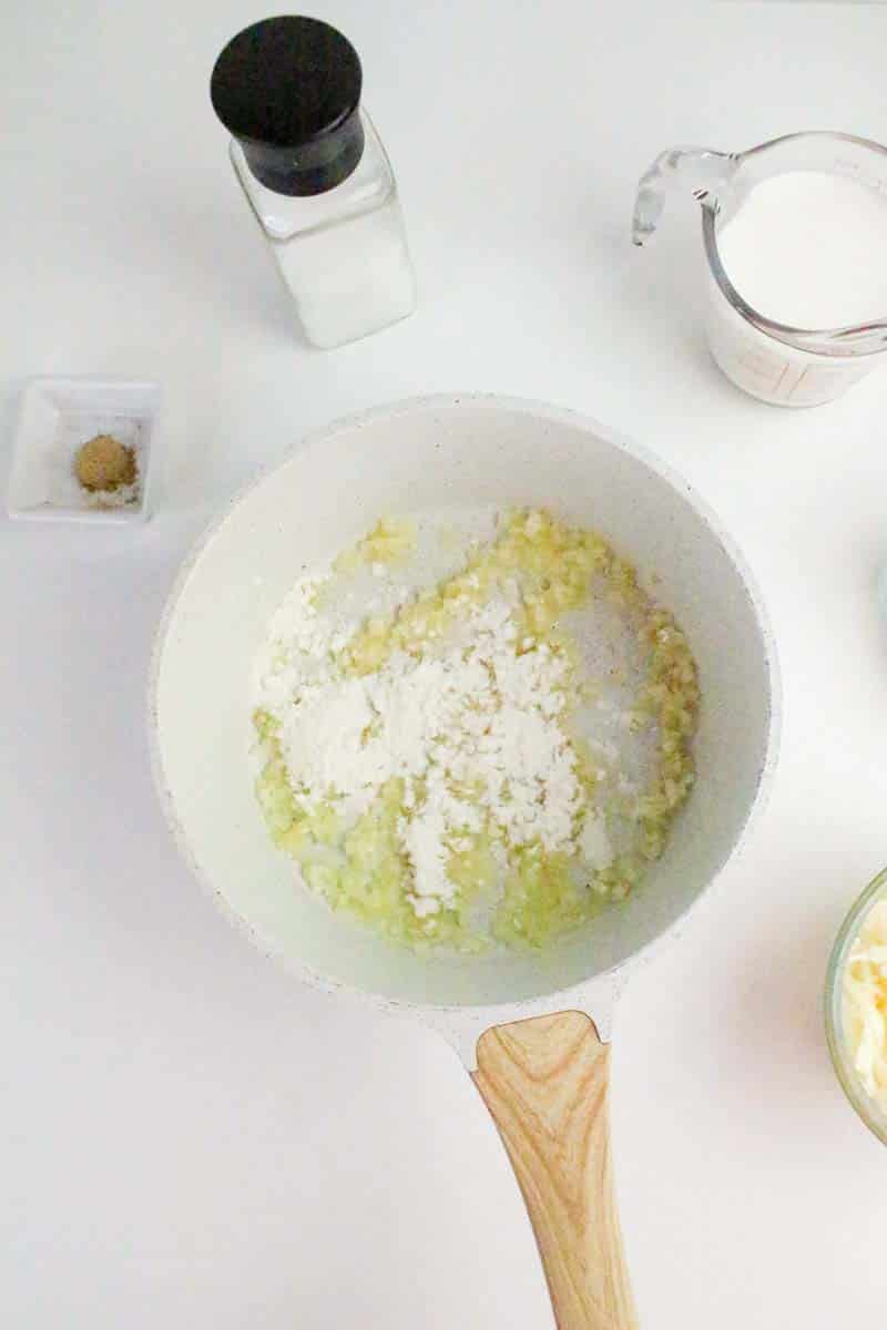 Flour added to a saucepan filled with butter and cooked onion to make a creamy cheese dip for chips. Hostess At Heart