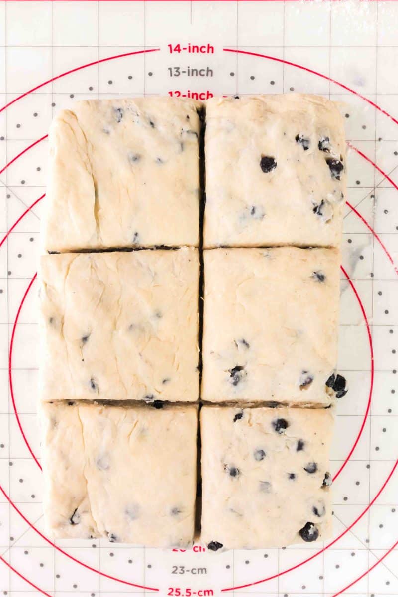 Blueberry biscuit dough shaped into a rectangle and sliced into 5 pieces. Hostess At Heart
