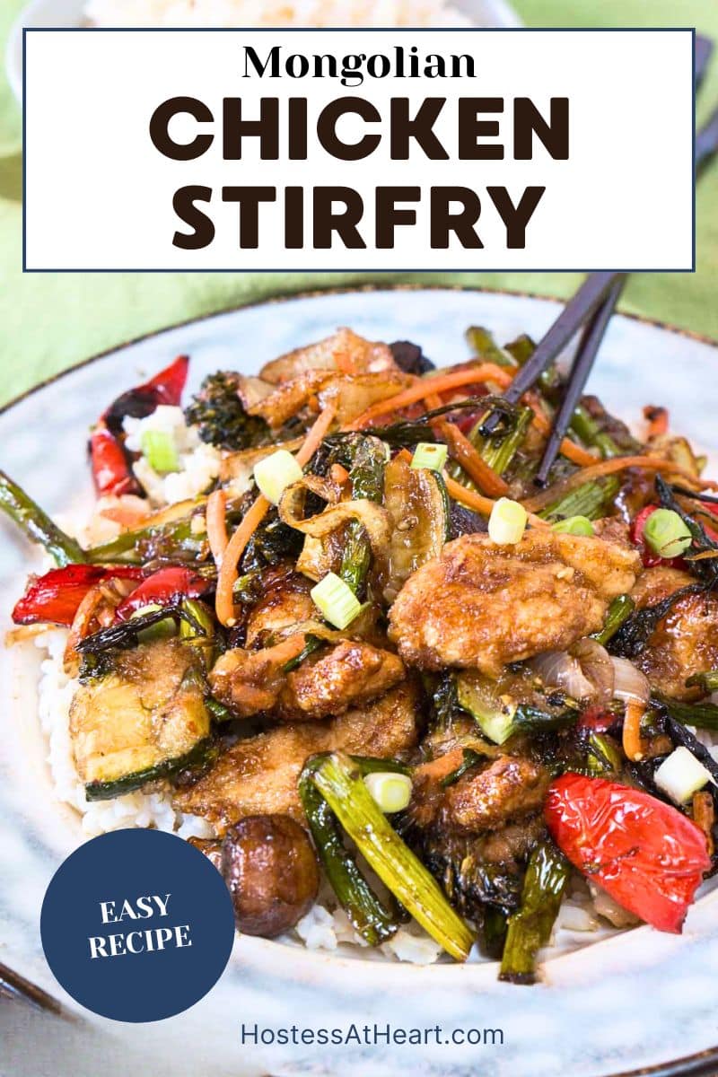 An image for Pinterest of a plate filled with colorful stirfried veggies and crispy brown pieces of chicken in an Asian sauce over rice. Hostess At Heart