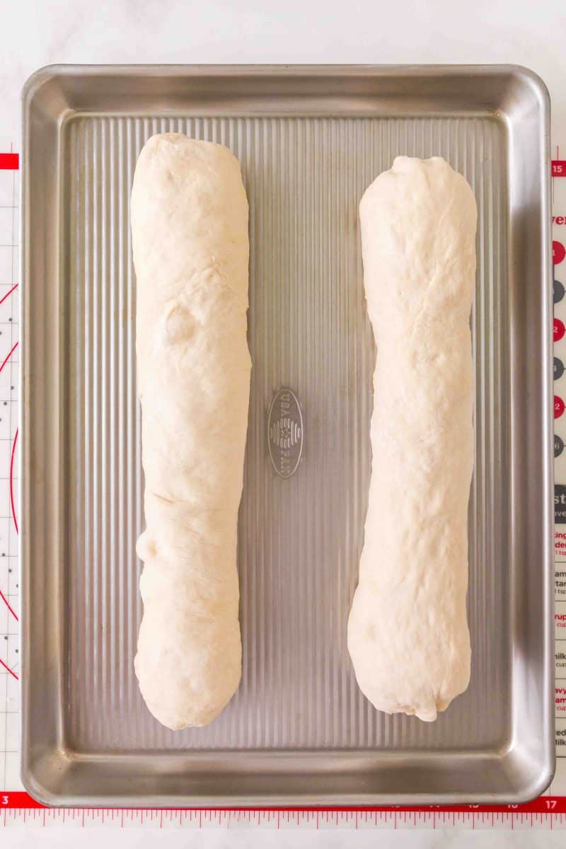 Shaped French Bread baguettes on a baking sheet for their second rise. Hostess At Heart